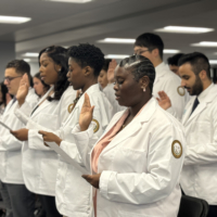 Diverse medical students of Ponce Health Sciences University PHSU recite hippocratic oath at white coat ceremony