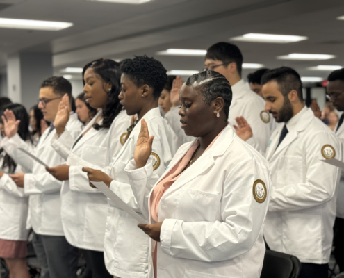 Diverse medical students of Ponce Health Sciences University PHSU recite hippocratic oath at white coat ceremony