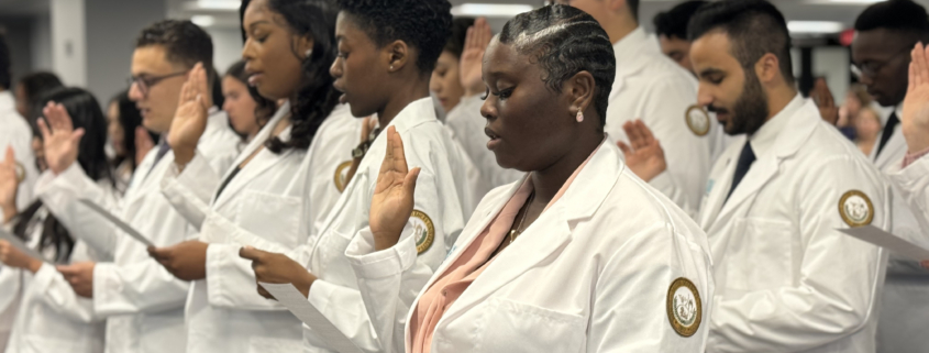 Diverse medical students of Ponce Health Sciences University PHSU recite hippocratic oath at white coat ceremony